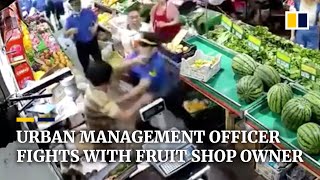 Urban management officer fights with fruit shop owner in China [upl. by Souza221]