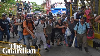 Migrant caravan in Guatemala breaks through border fence into Mexico [upl. by Elletnuahs]